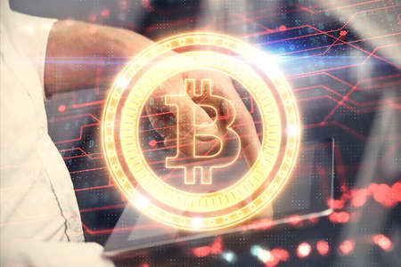 Double exposure of man's hands holding and using a phone and crypto currency blockchain theme...