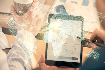 Double exposure of man's hands holding and using a phone and international business theme drawing.