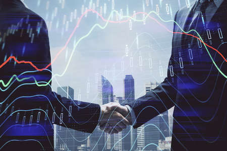Double exposure of forex graph hologram and handshake of two men. Stock market concept.
