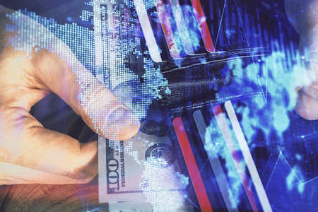 Multi exposure of forex graph drawing hologram and USA dollars bills and man hands. Technical...