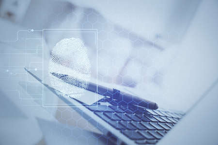 Computer on desktop in office with finger print drawing. Double exposure. Concept of business data...