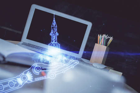 Desktop computer background in office and start up theme hologram drawing. Double exposure. Startup concept.の写真素材
