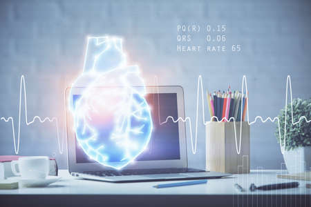 Desktop computer background and heart drawing. Double exposure. Medical study and healthcare concept.の写真素材