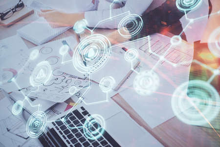 Social network theme hologram over hands taking notes background. Concept of global international...
