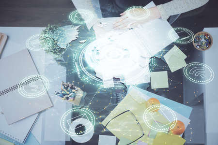Social network theme hologram over hands taking notes background. Concept of global international people connect. Double exposureの写真素材