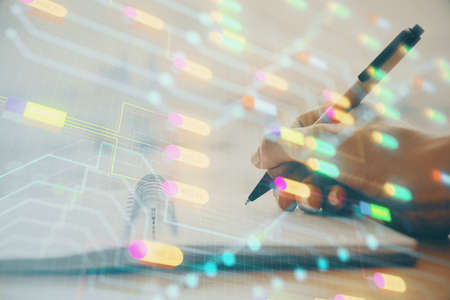 Double exposure of writing hands on background with data solution hologram on front. Technology...
