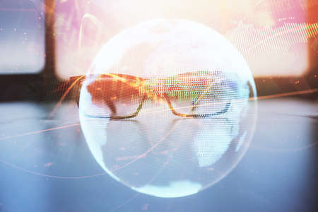 Business theme hologram with glasses on the table background. Concept of search. Double exposure.の写真素材