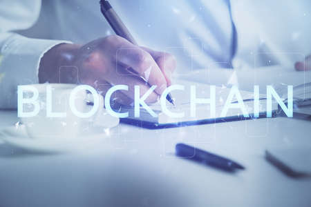 Man's hands working with notes background. Cryptocurrency and finance concept. Double exposure.