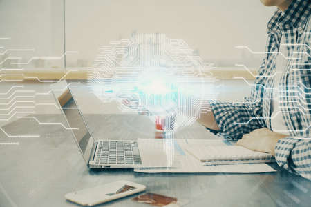 Man typing on keyboard background with brain hologram. Concept of big Data. Double exposure.の写真素材