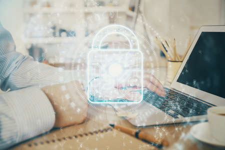 Double exposure of lock icon with man working on computer on background. Concept of network...