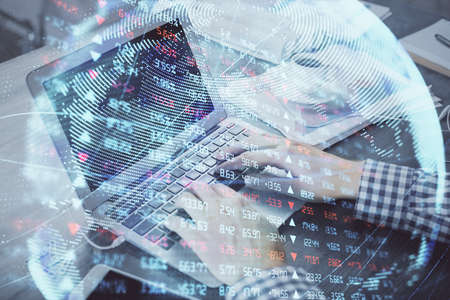 Multi exposure of businessman working on laptop on background. International business hologram in front. Concept of success.の写真素材