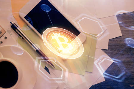 Double exposure of blockchain theme hologram over table with phone. Top view. Crypto technology...