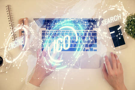 Double exposure of woman hands working on computer and blockchain theme hologram drawing. Top View....