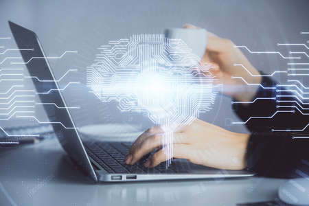Multi exposure of woman hands working on computer and human brain hologram drawing. Ai tech concept.の写真素材
