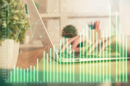Double exposure of woman hands typing on computer and forex chart hologram drawing. Stock market...