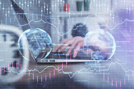 Double exposure of woman hands typing on computer and forex chart hologram drawing. Stock market...