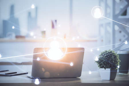 Computer on desktop with social network hologram. Double exposure. Concept of international people connections.の写真素材