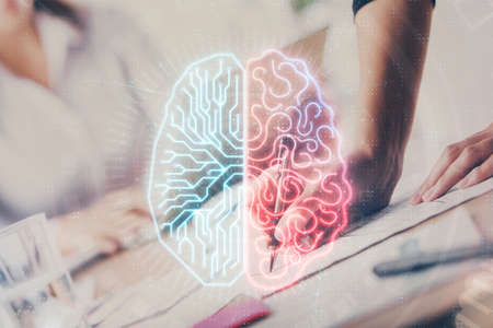Double exposure of woman's writing hand on background with brain hud. Concept of learning.