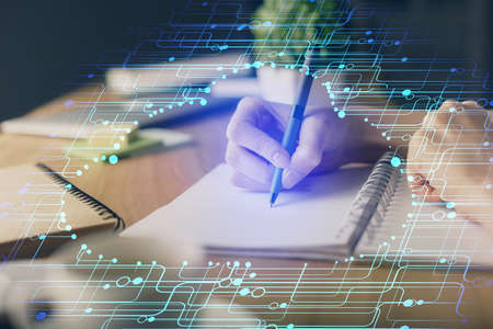Double exposure of hands making notes with digital coding icons. Computer learning concept.