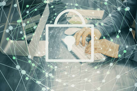 Double exposure of lock icon with man working on computer on background. Concept of network...