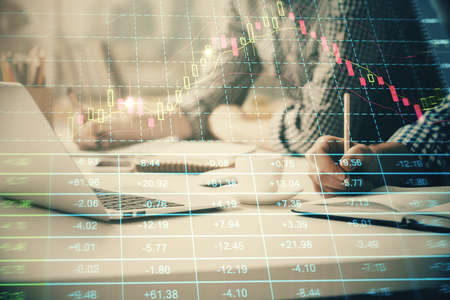 Multi exposure of forex chart with man working on computer on background. Concept of market...