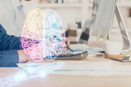 Businessman with computer background with brain theme hologram. Concept of brainstorm. Multi exposure.の写真素材