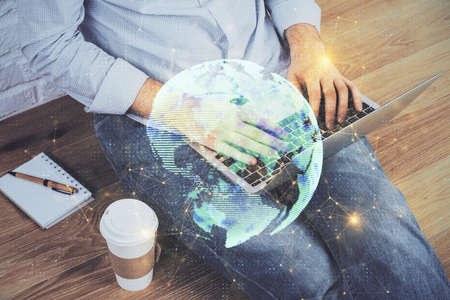 Media network theme hologram with man working on computer on background. Concept of internet communication. Double exposure.の写真素材