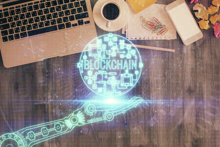 Blockchain theme hologram drawings over computer on the desktop background. Top view. Double exposure.の写真素材