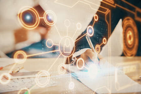 Double exposure of social network theme drawing over people taking notes background. Concept of...