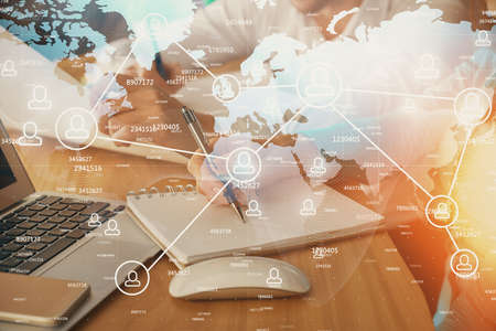 Double exposure of social network theme drawing over people taking notes background. Concept of...