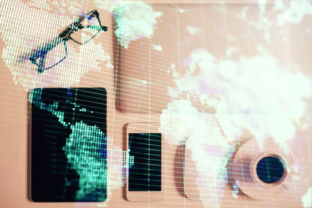 Double exposure of business theme hologram over desktop with phone. Top view. Mobile international...