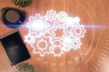 Double exposure of business theme hologram over desktop with phone. Top view. Mobile international...
