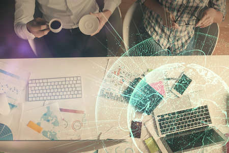 Double exposure of man and woman working together and social network theme hologram drawing....