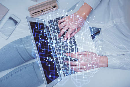 Double exposure of woman working on computer andhuman brain hologram drawing. Top View. Ai concept.