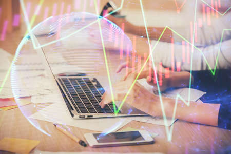 Multi exposure of woman hands typing on computer and financial chart hologram drawing. Stock market...