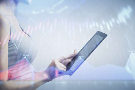 Double exposure of forex chart sketch hologram and woman holding and using a mobile device. Stock...