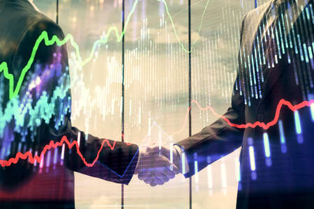Double exposure of forex graph hologram and handshake of two men. Stock market concept.