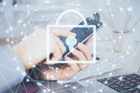 Multi exposure of man's hands holding and using a digital device and lock drawing. Security concept.