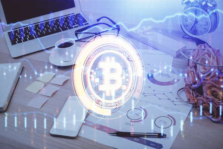 Double exposure of blockchain and crypto economy theme hologram and table with computer background....