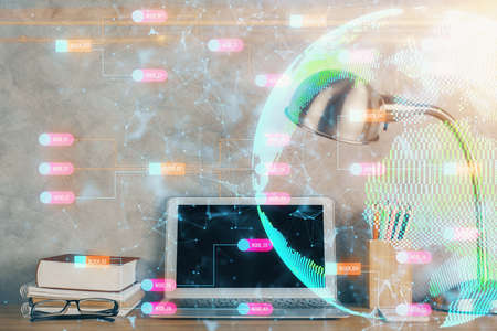 Double exposure of desktop with computer and world map hologram. International data network concept.の写真素材