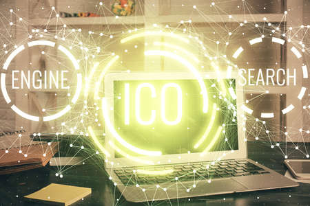 Multi exposure of blockchain theme hologram and table with computer background. Concept of bitcoin crypto currency.の写真素材