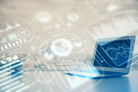 Computer on desktop in office with technology theme hologram. Multi exposure. Tech concept.