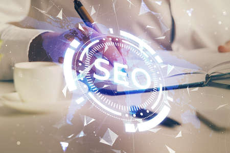 Man's hands with seo theme double exposure icon. Concept of search optimization.の写真素材