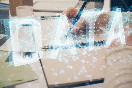 Double exposure of writing hand on background with data solution technology hologram. Ai concept.