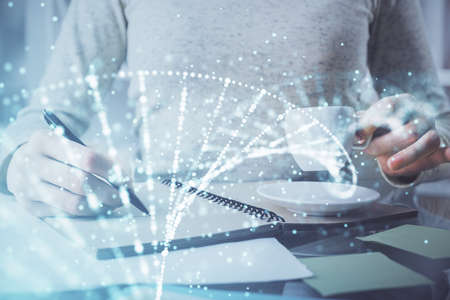 DNA theme hologram over woman's hands writing background. Concept of education. Double exposureの写真素材