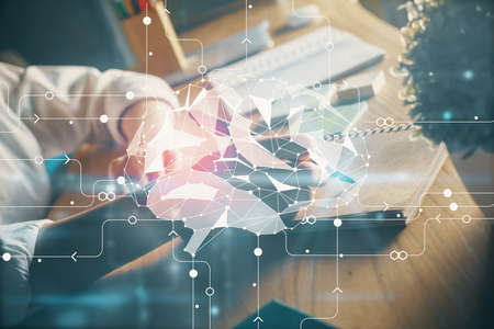 Multi exposure of writing hand on background with brain hologram. Concept of self learning.