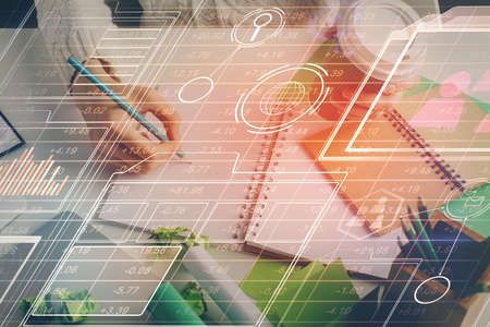 Double exposure of hands making notes background with technology and digital coding huds. Data...