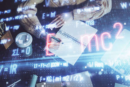 Science formula hologram over woman's hands taking notes background. Concept of study. Double...