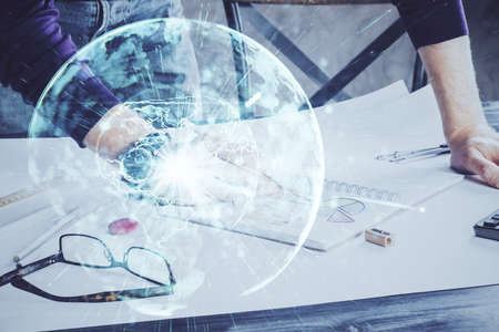 Double exposure of Man writing in notepad with business icons on background. Concept of international business.の写真素材