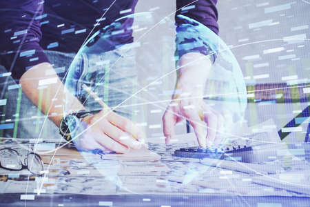 Double exposure of Man writing in notepad with business icons on background. Concept of...